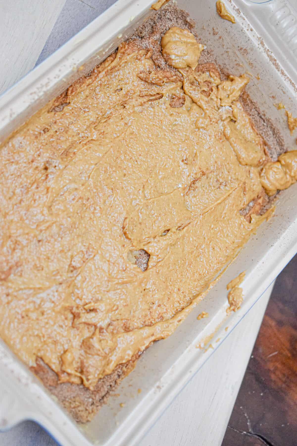 The cinnamon sugar is added to the top of the cake batter and then more cake batter is added to the top of that.