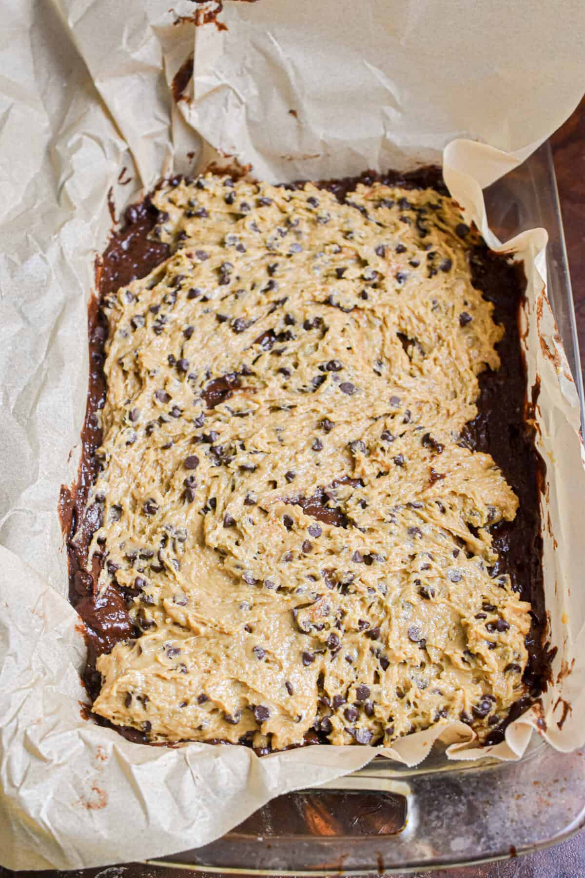 The cookie batter is added to the top of the brownie batter.