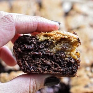 A hand is holding a sourdough brookie.