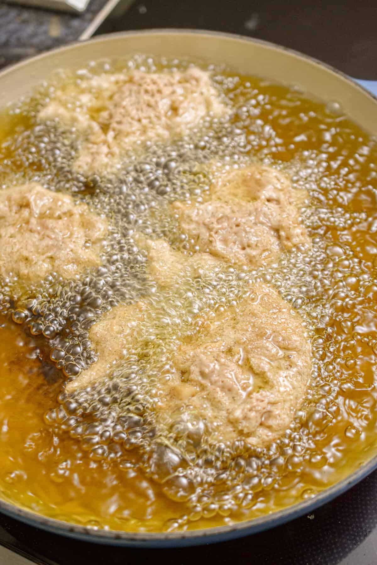 The fritters are frying in the oil.