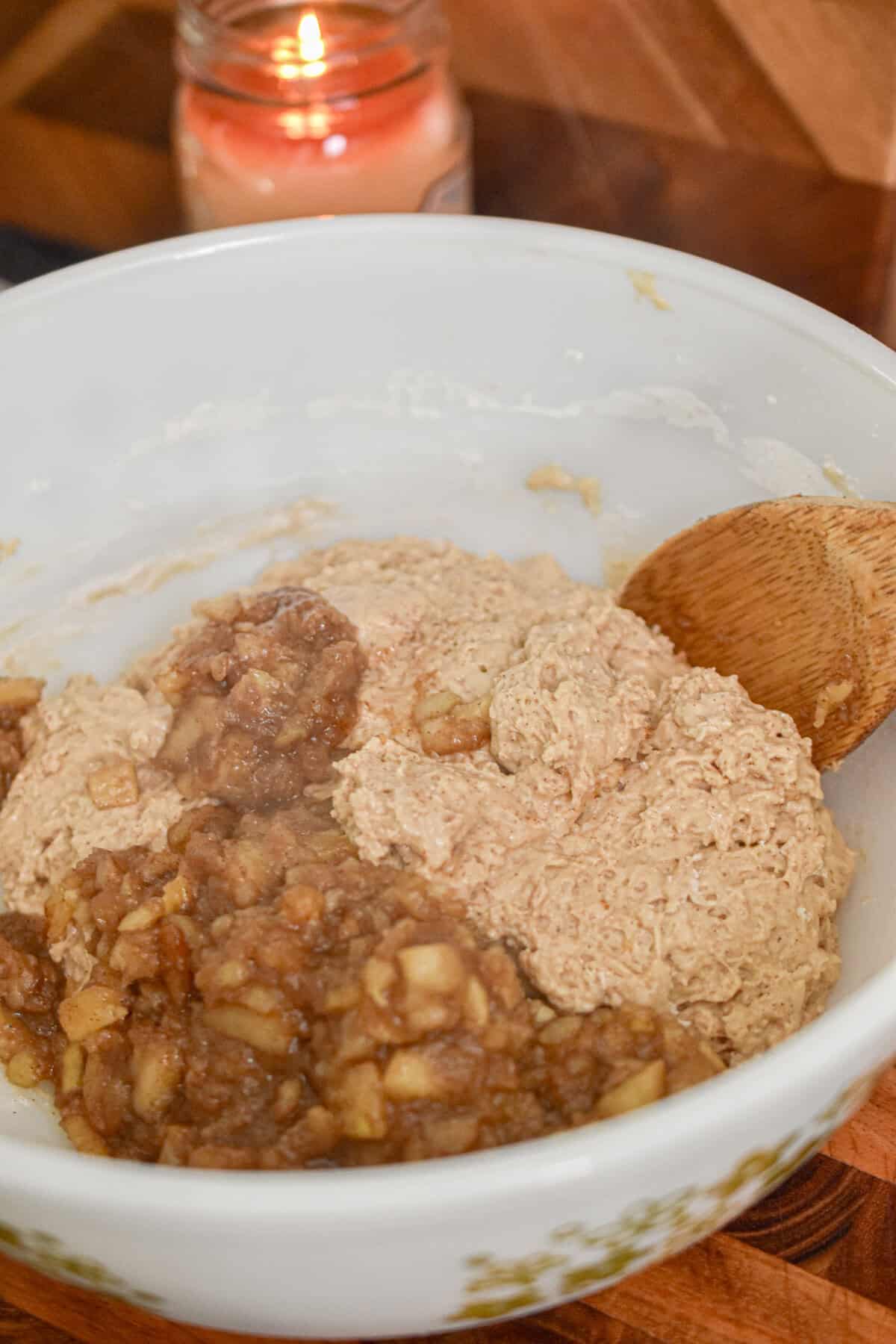 The sauteed apples is added to the batter.